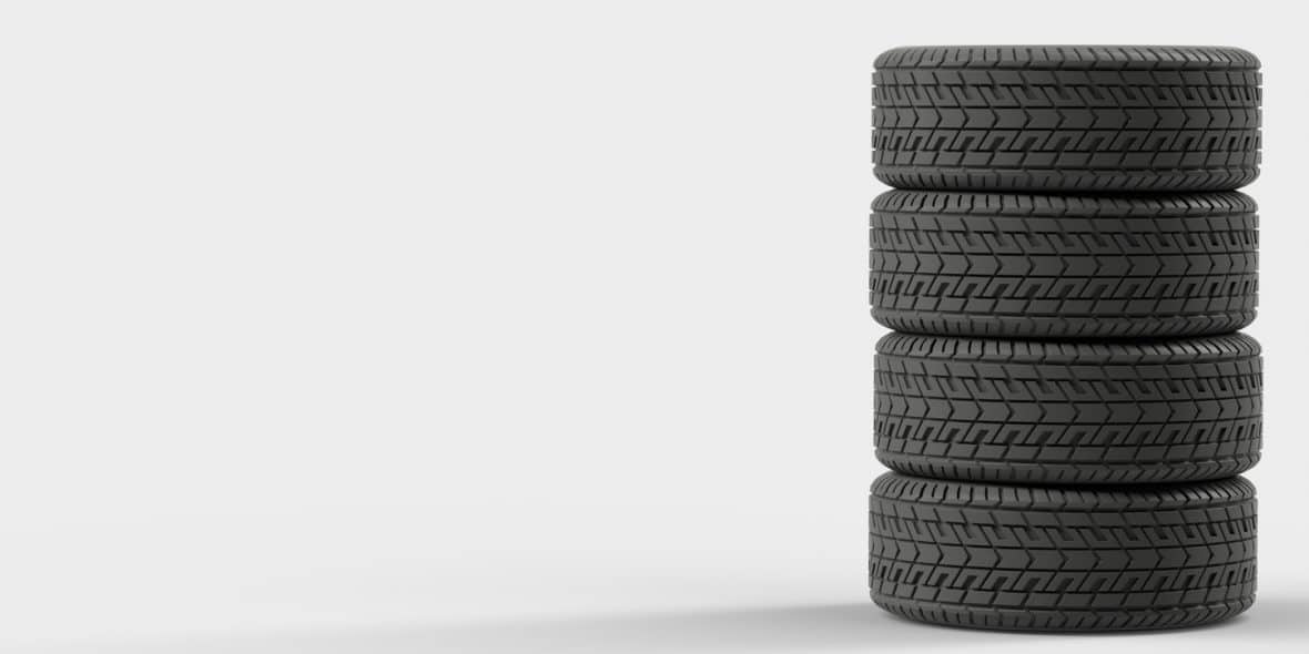 Four tires stacked on top of each other, ready to be put into seasonal storage.